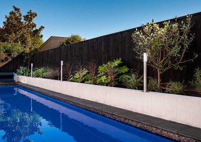 Morgan+Stone Fibreglass swimming pool with walled garden border with built in lights